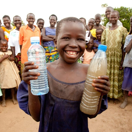 Girl holding one glass of clean water and one glasss of dirty water